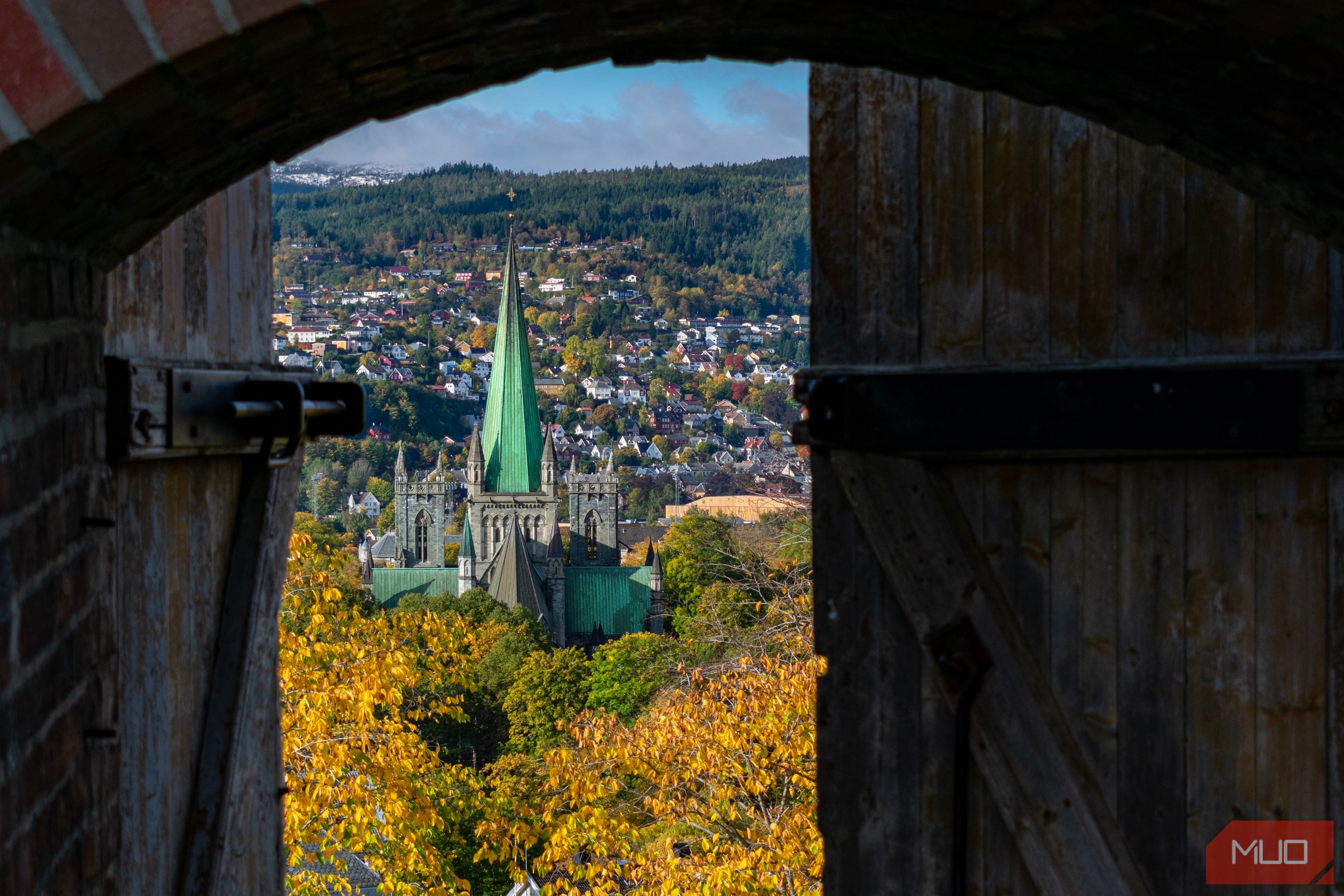 A picture of a church taken through an arch door