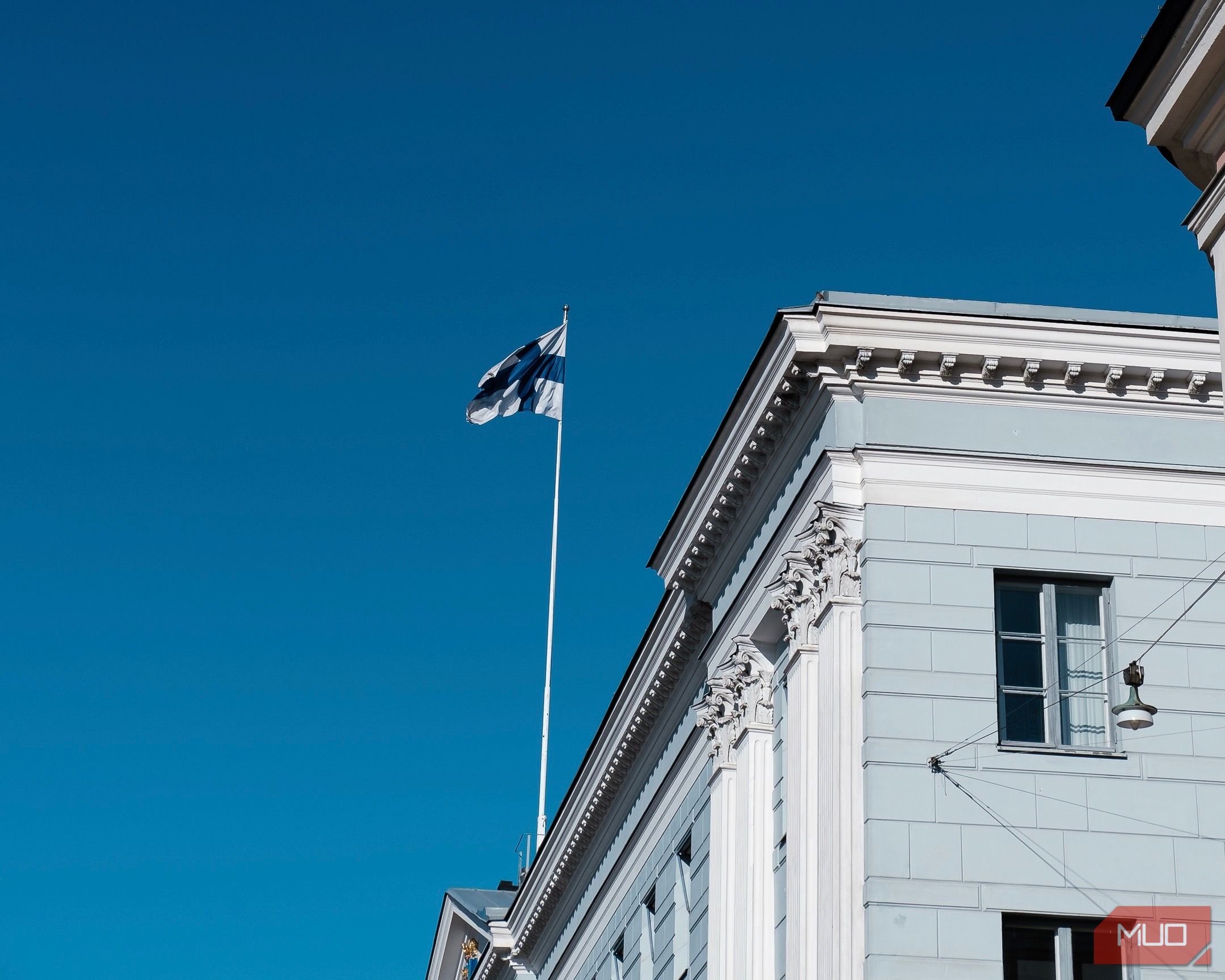 A picture of a flag on a building in the wind