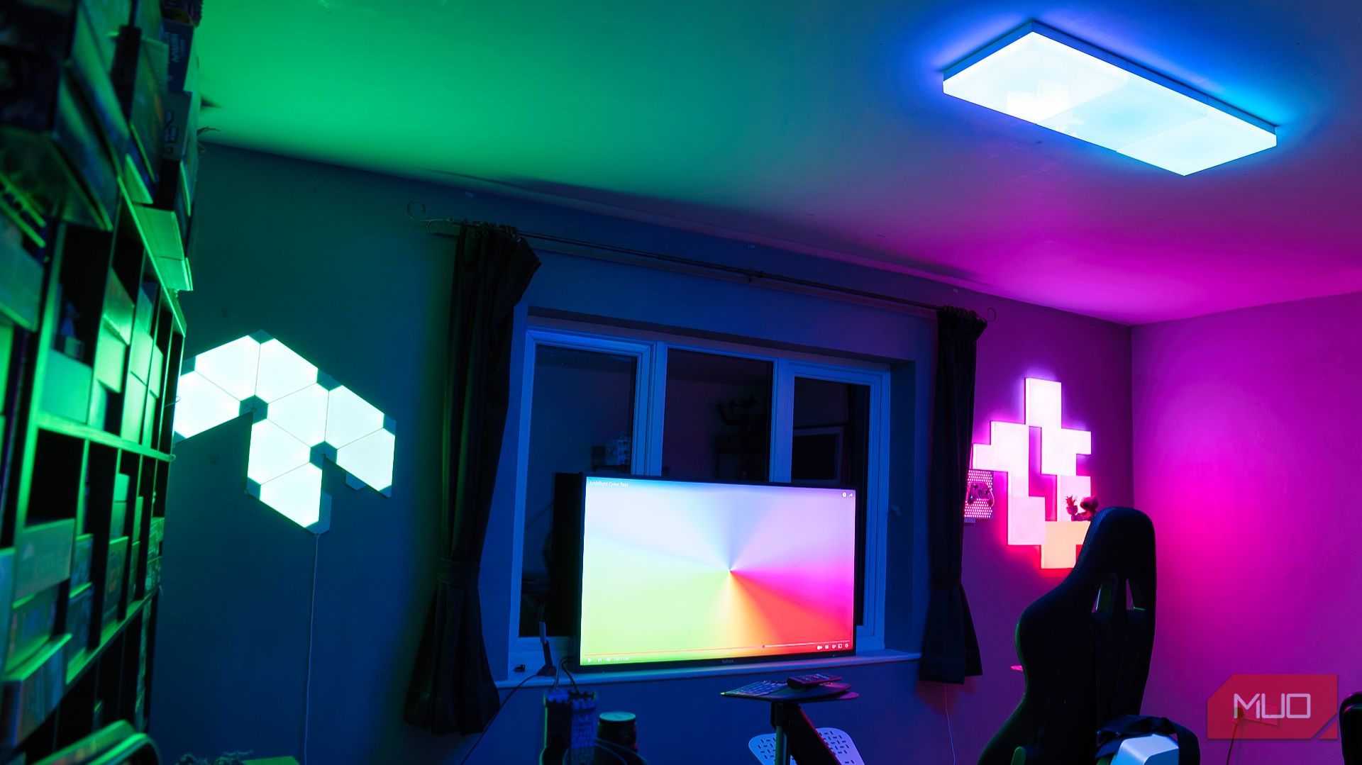 Nanoleaf Blocks review - complete gaming room wide angle shot showing older Nanoleaf panels and Skylight alongside Blocks synced to screen content