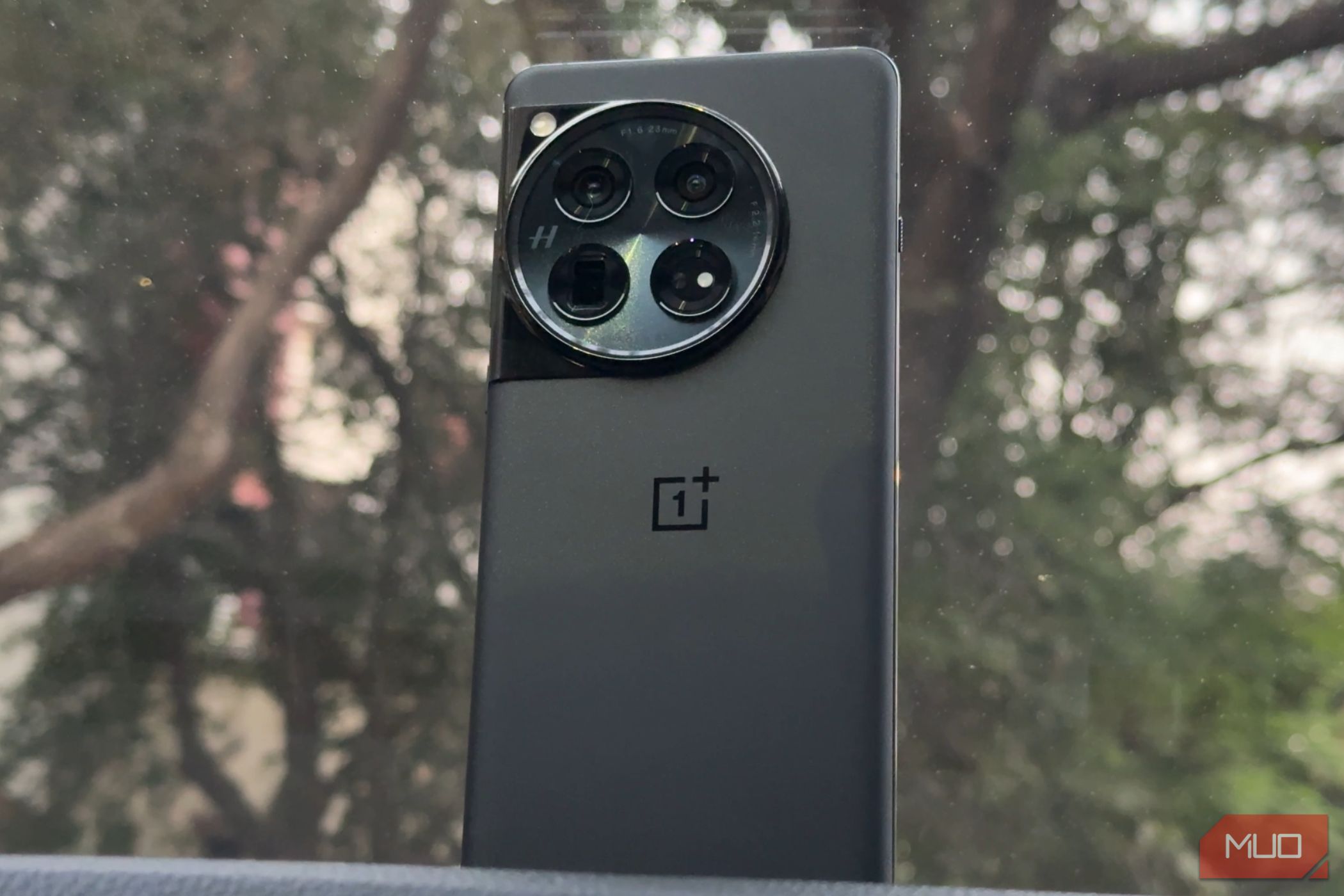 An image showcasing the OnePlus 12 placed on a car dashboard