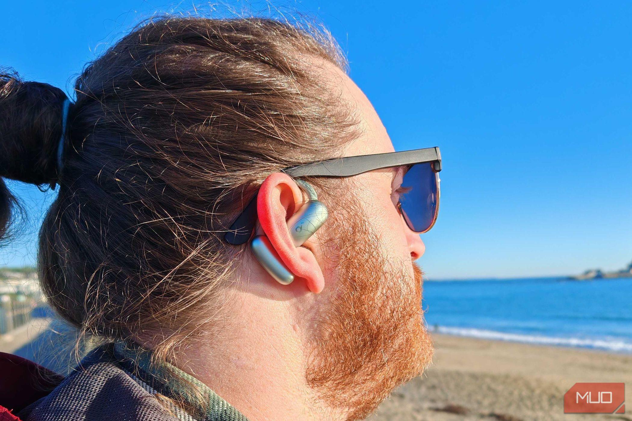 soundcore aerofit 2 earbuds worn by male in ear.