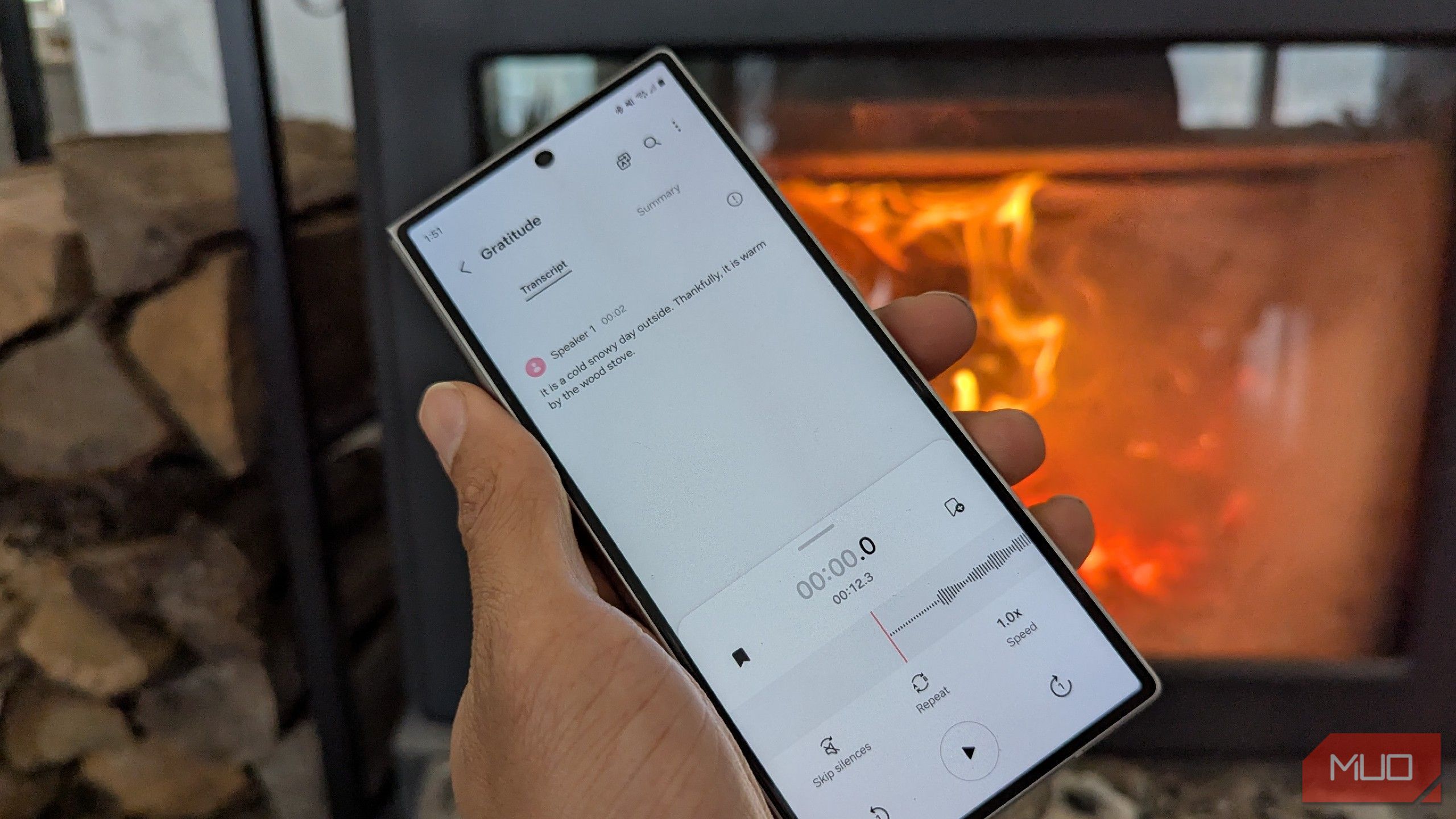 A voice recording being transcribed next to a wood stove.