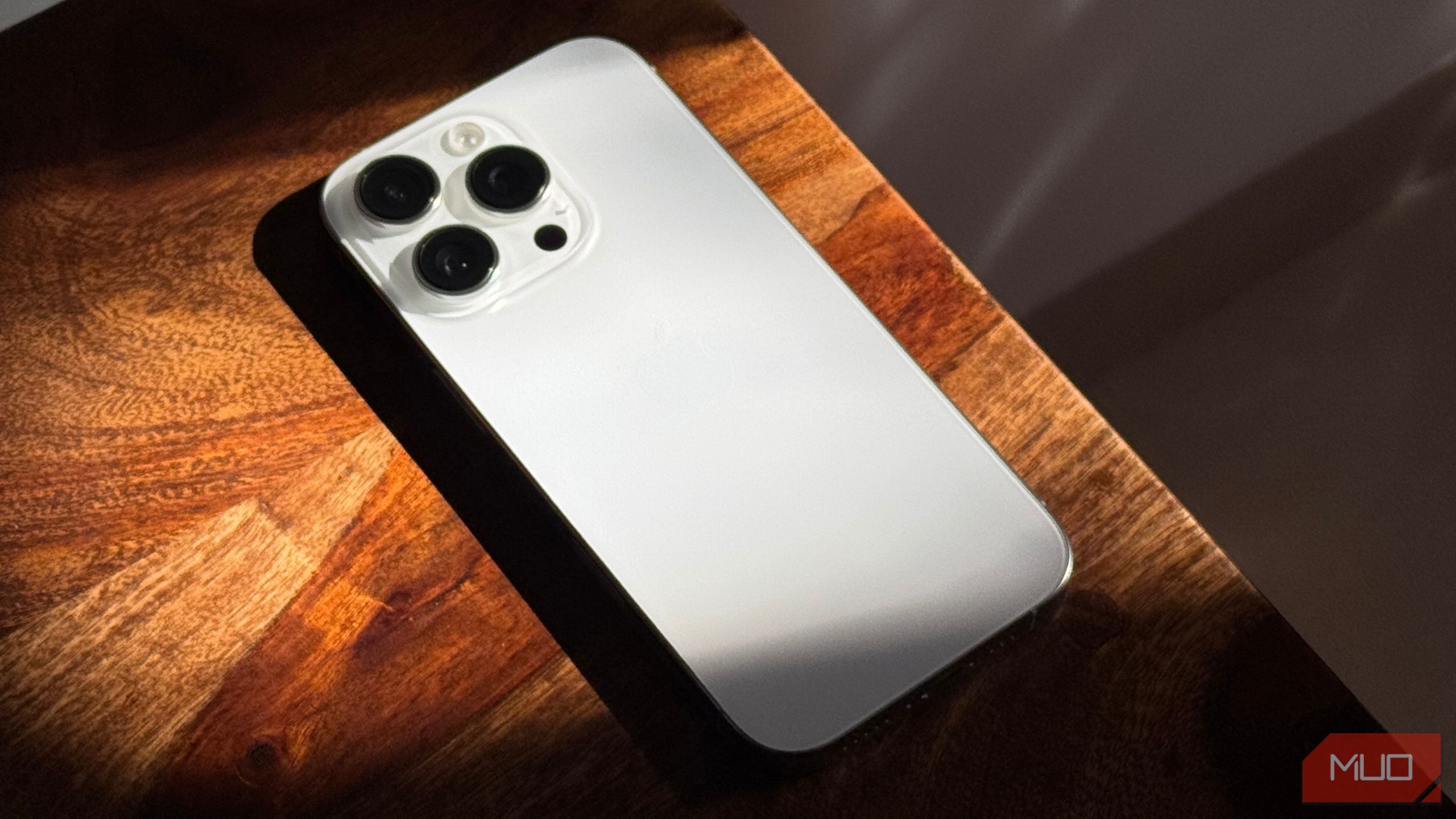 iPhone 16 Pro in White Kept on a Wooden Table