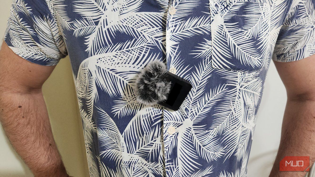 A lavalier mic clipped onto a shirt.