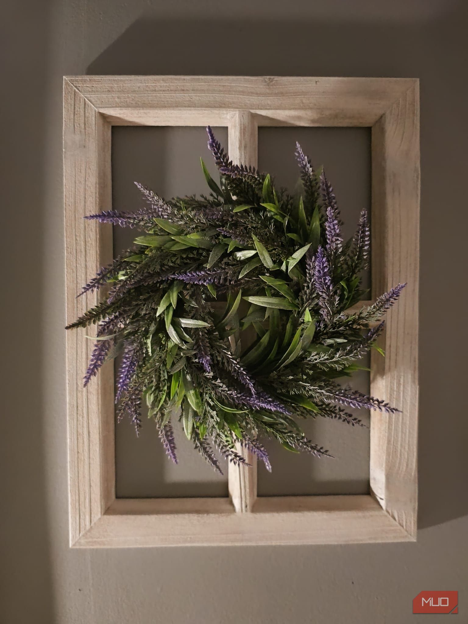 A wooden frame and wreath decoration in low lighting—HDR disabled