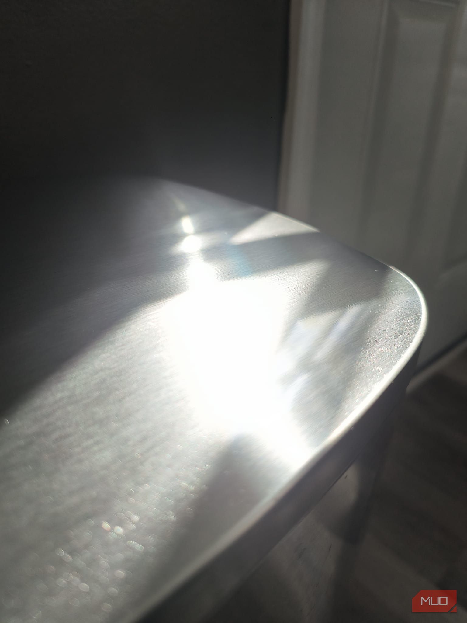 The top of a metallic trashcan with the sun reflecting off it—HDR disabled