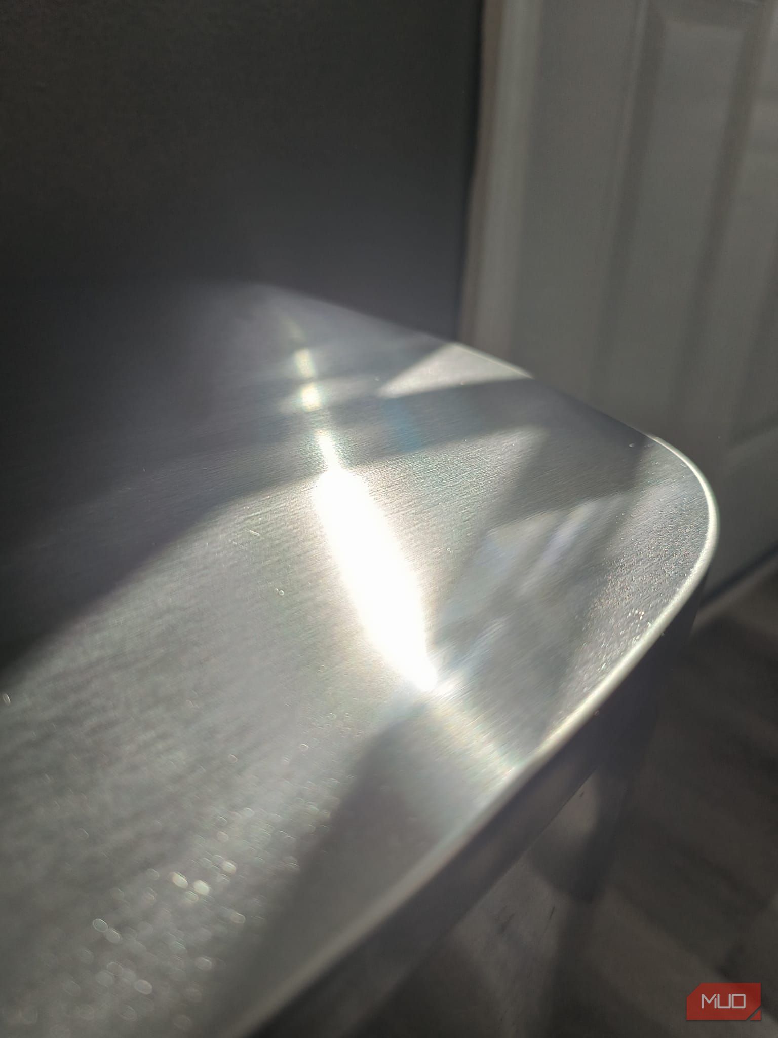 The top of a metallic trashcan with the sun reflecting off it—HDR enabled