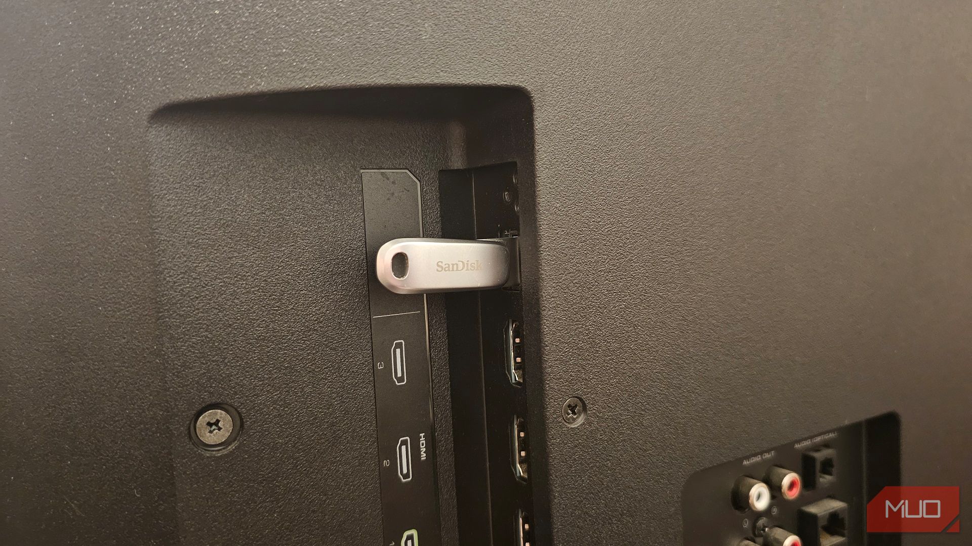 A SanDisk USB stick plugged into a Vizio smart TV's USB port
