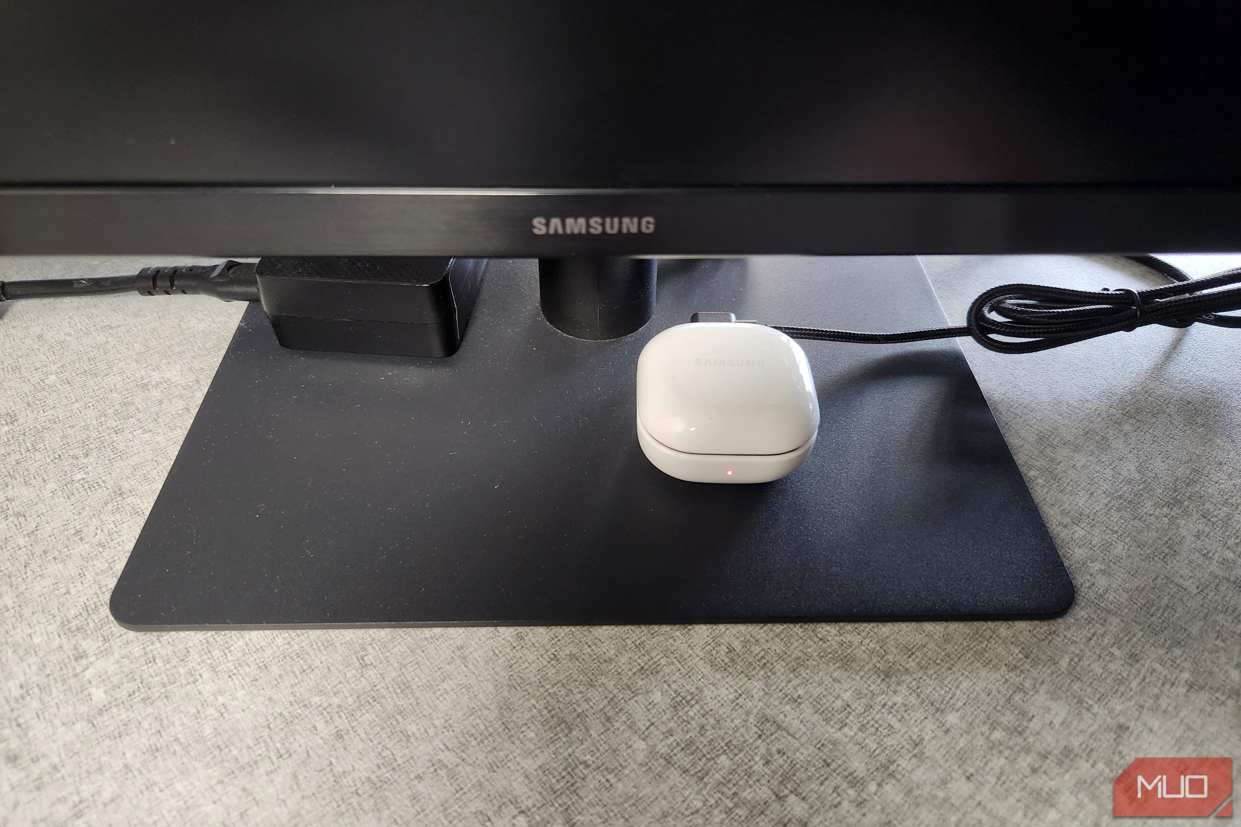 Bluetooth earbuds charging via USB port in monitor