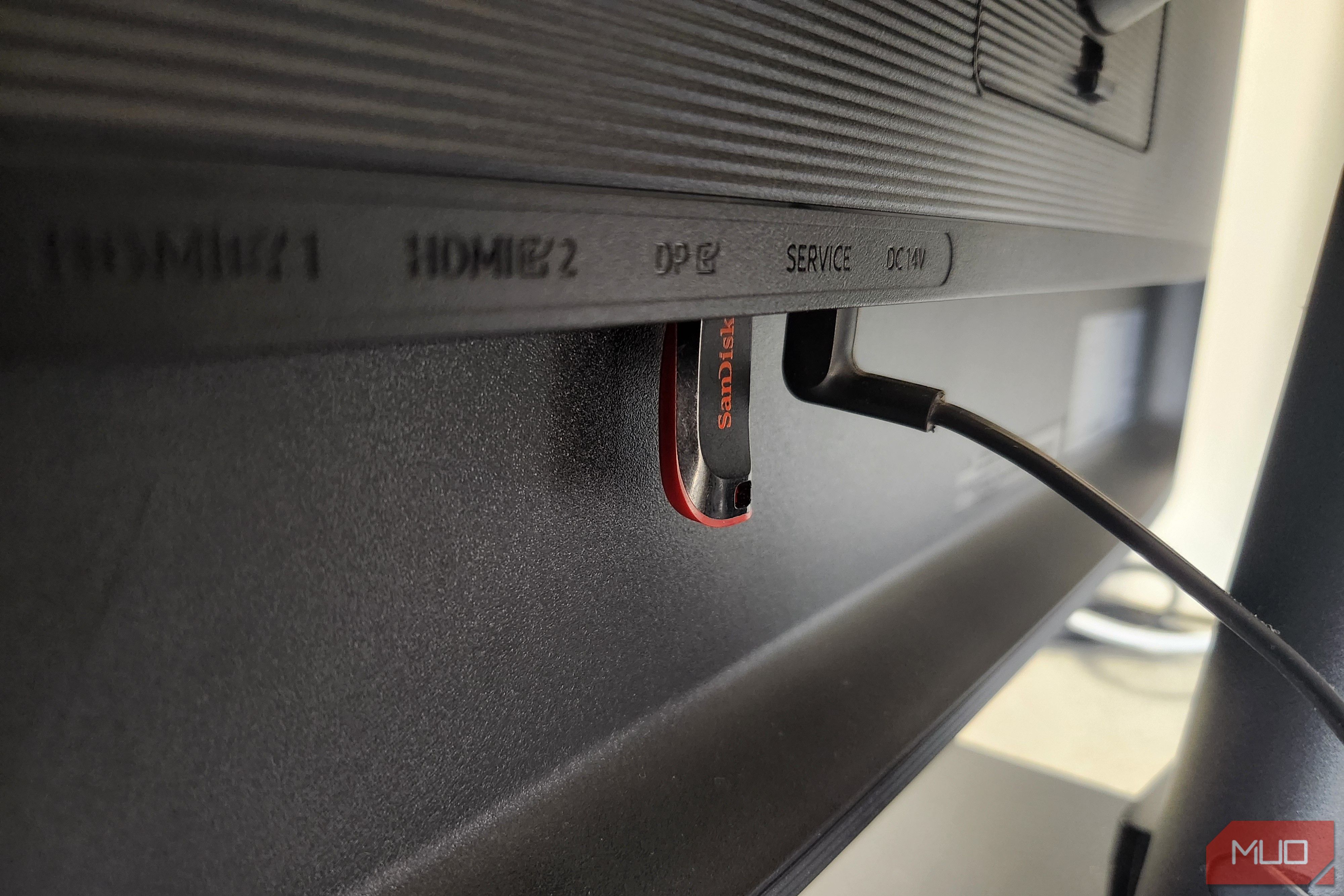 Close-up of a black USB flash drive connected to monitor