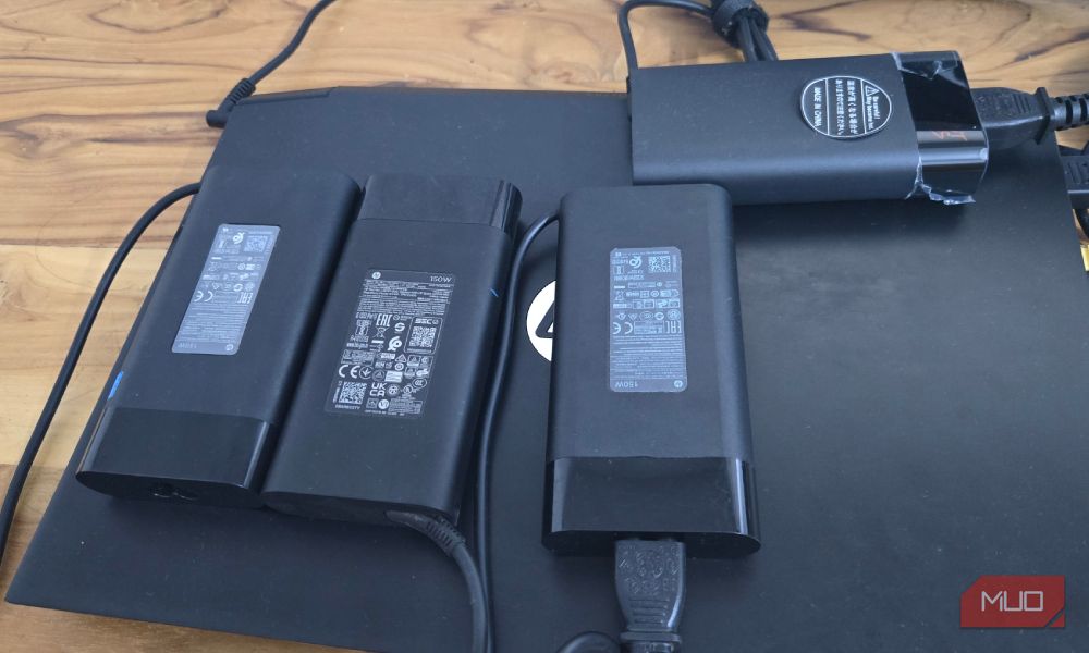 four Hp 150W charger placed on a HP laptop