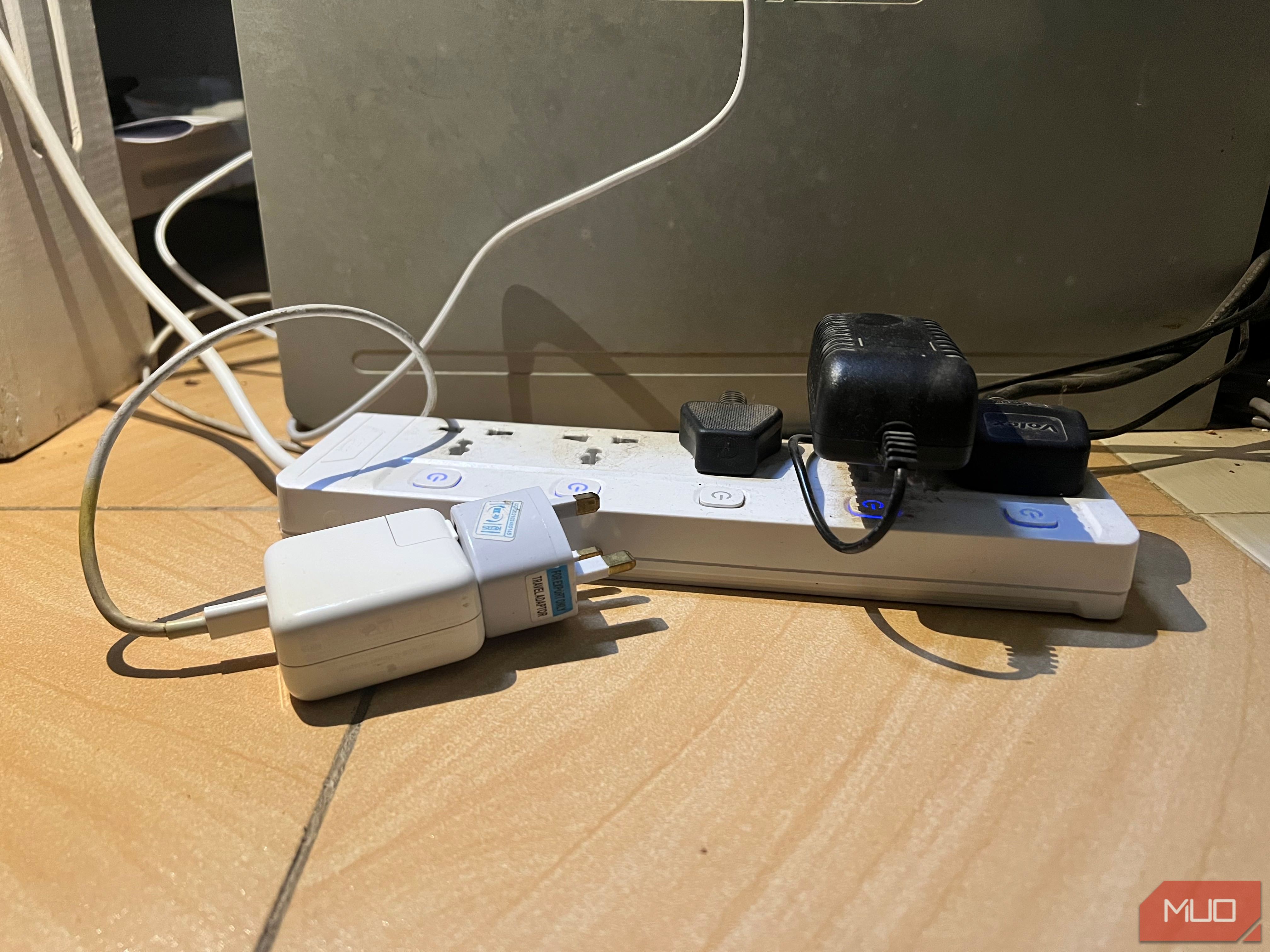 A laptop charger unplugged from a power strip