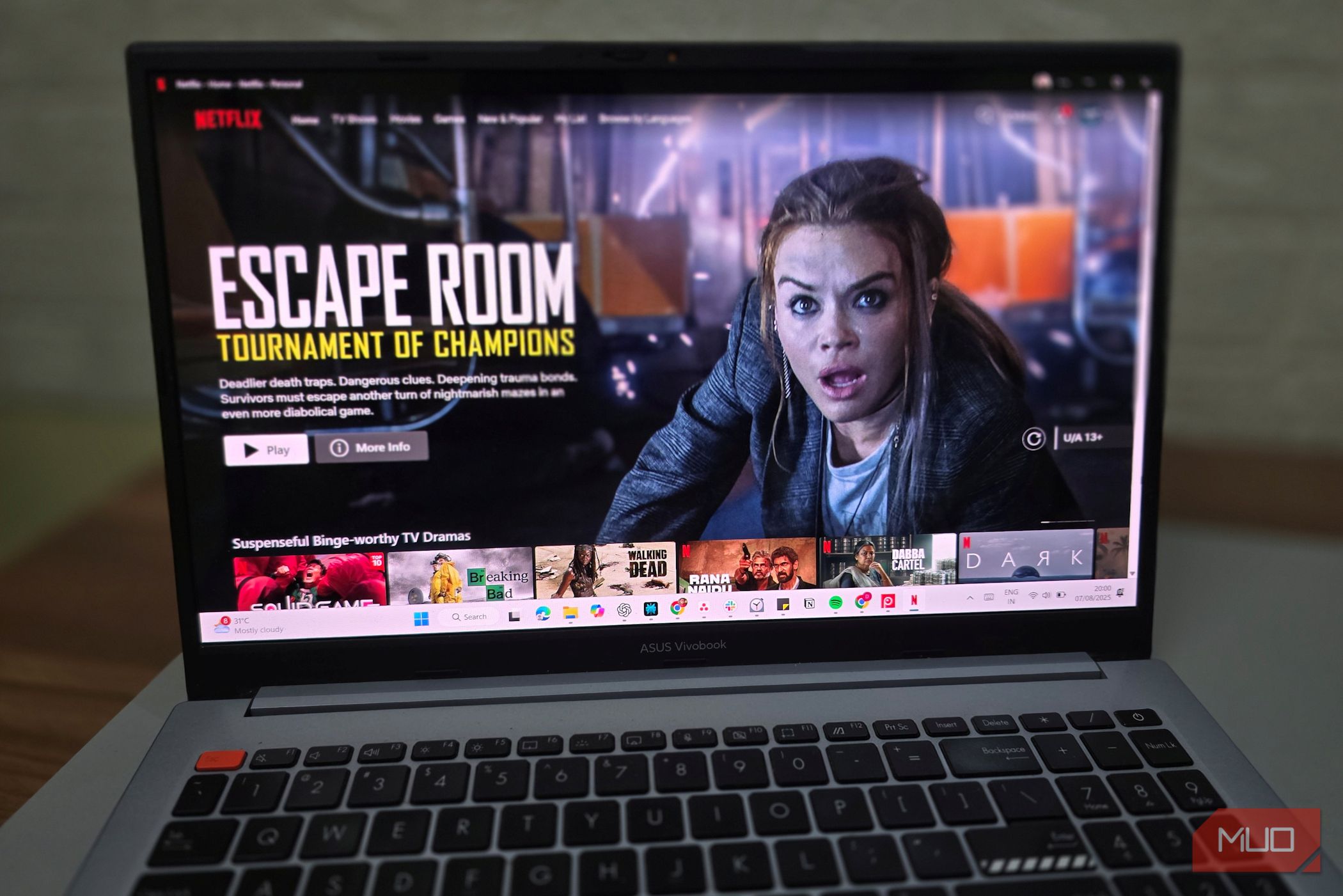 An open Netflix window appears on a laptop on a desk-1