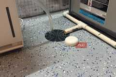 cropped-ring flood sensor next to floor drain in basement