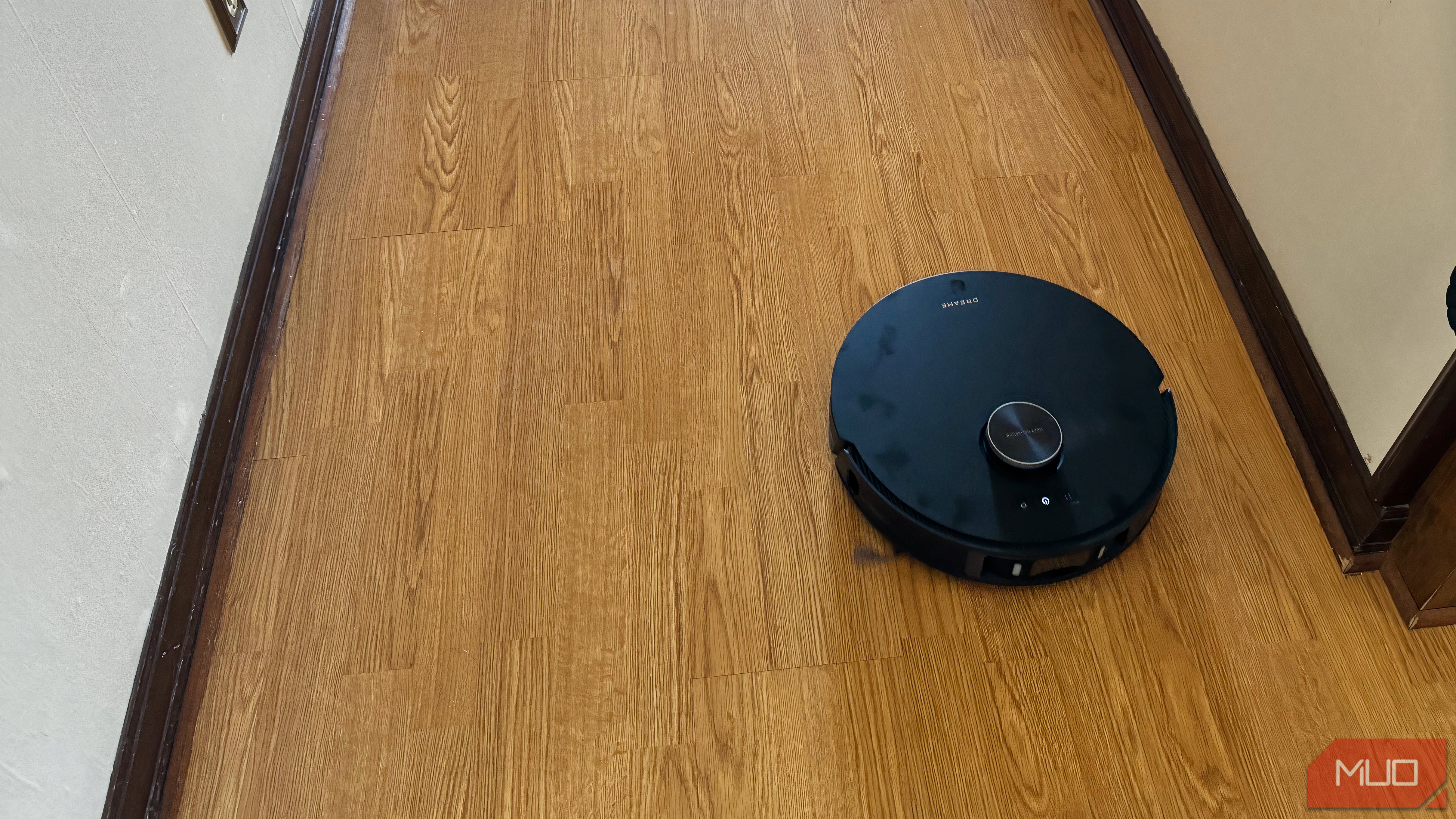 A robot vacuum moving on a kitchen floor.