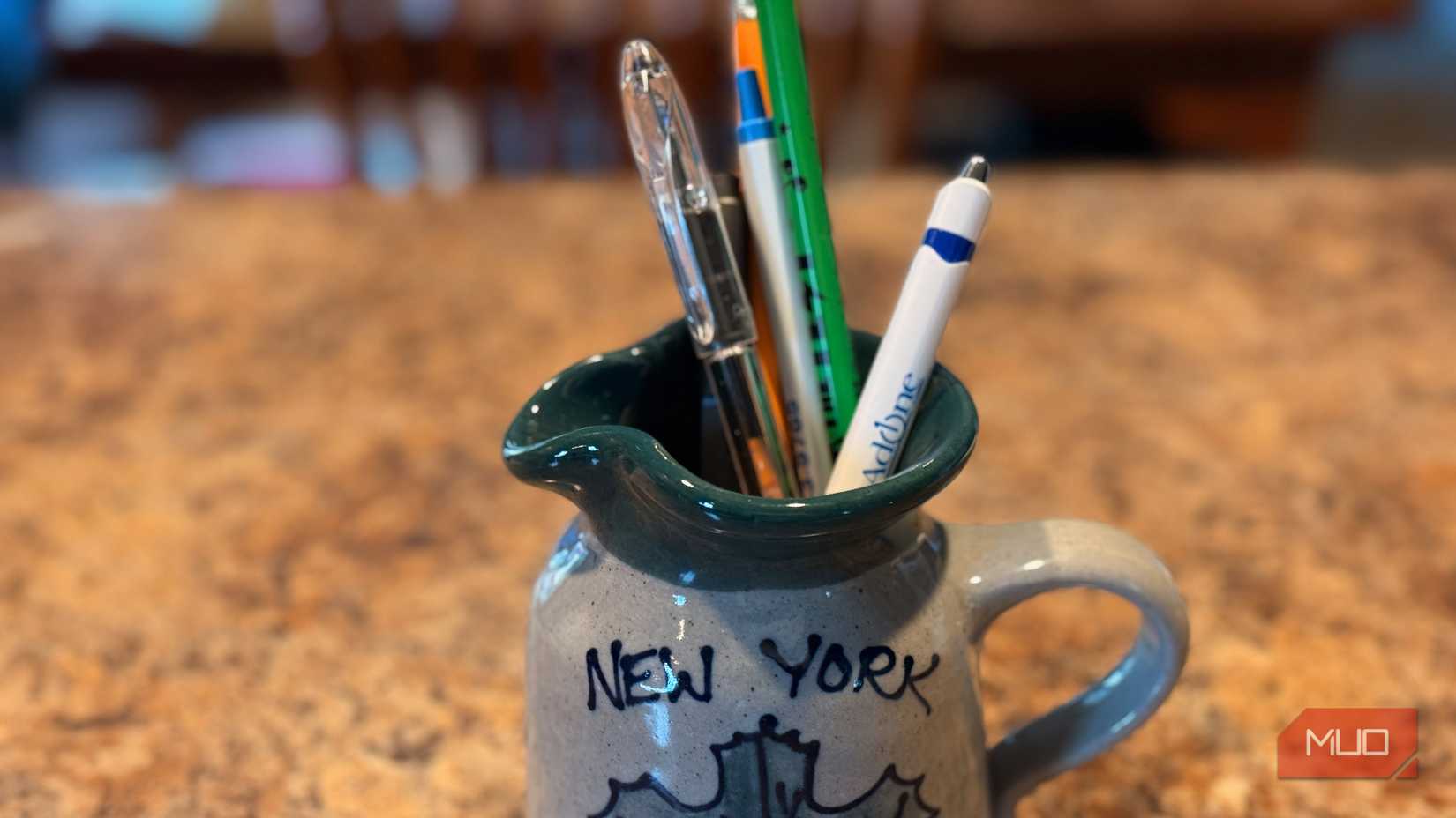 A ceramic crock used to store pens and pencils.