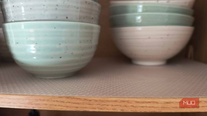 Plastic liner under bowls in a cabinet