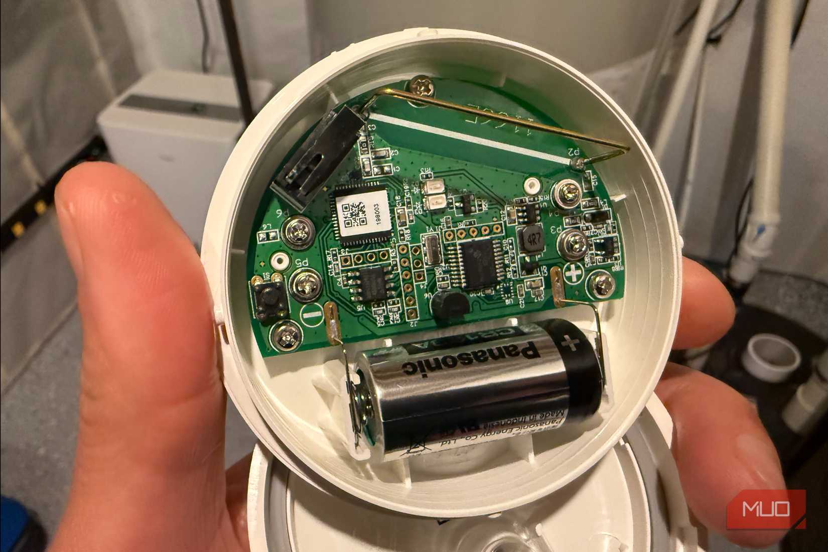 hand holding ring flood and freeze sensor showing circuit board