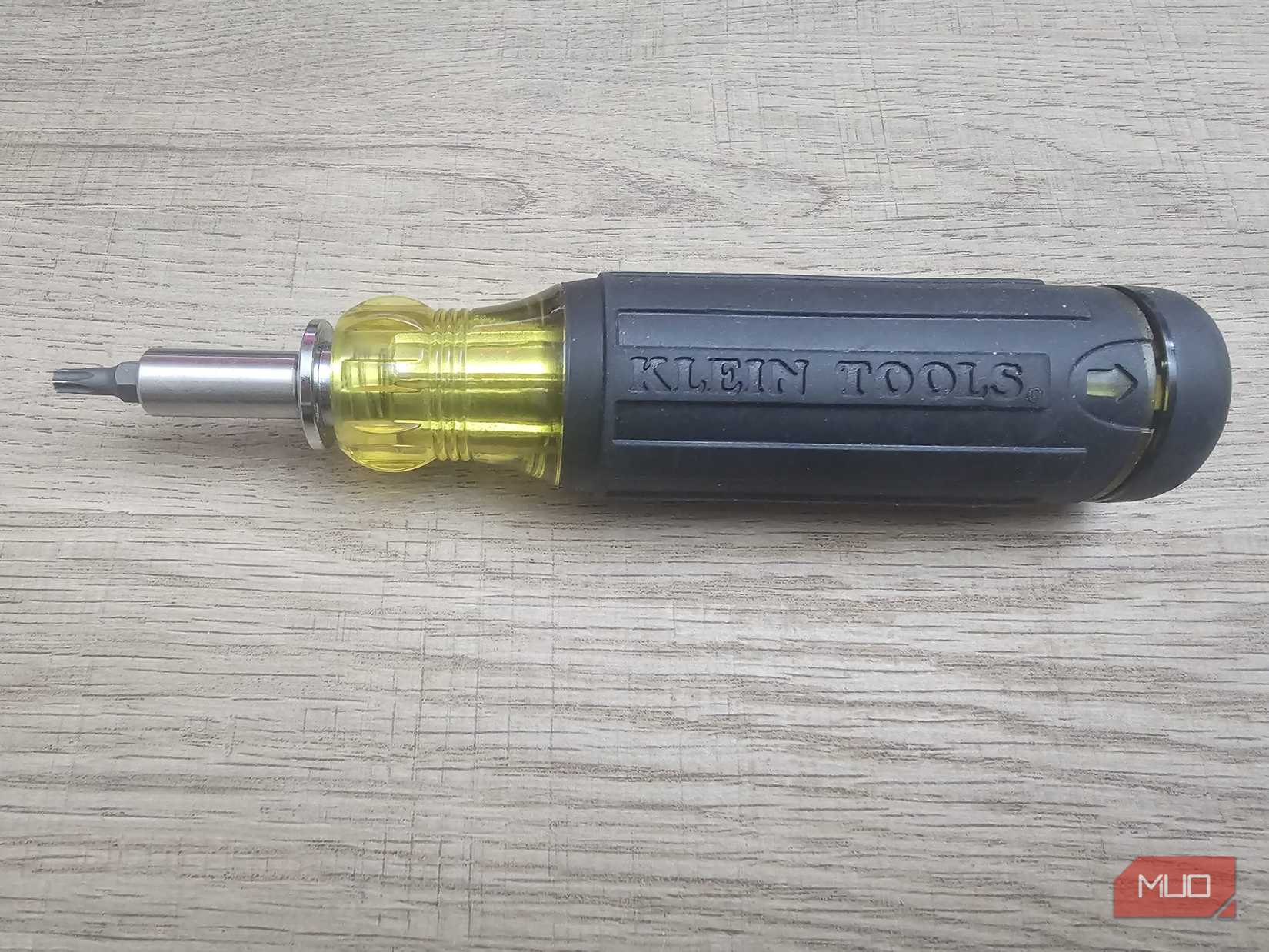 A multi-bit screwdriver placed against a desk